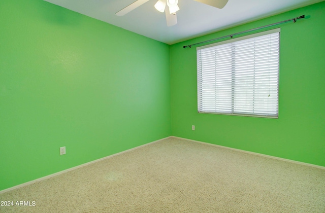 unfurnished room with ceiling fan and baseboards