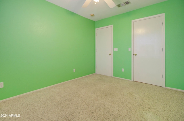 unfurnished bedroom with ceiling fan, visible vents, and baseboards