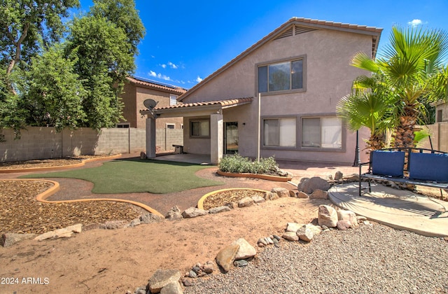 back of property featuring a patio area, fence, a tiled roof, and stucco siding