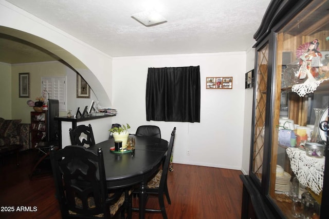 1211 E Fillmore St, Phoenix, AZ 85006 - dining room featuring wood finished floors, arched walkways, crown molding, and a textured ceiling