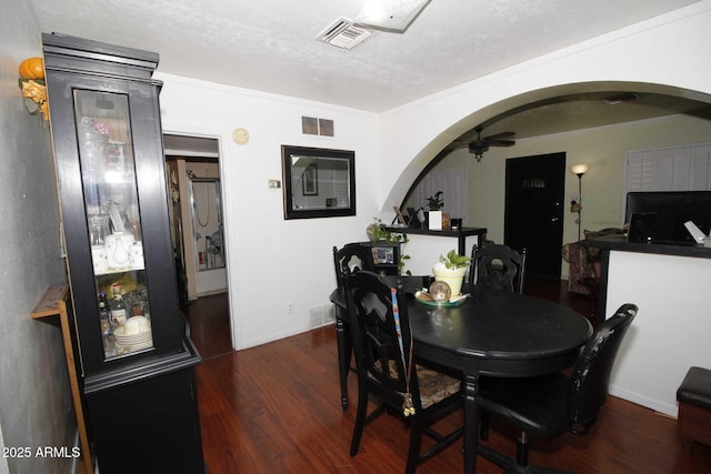 1211 E Fillmore St, Phoenix, AZ 85006 - dining room featuring a ceiling fan, arched walkways, wood finished floors, and a textured ceiling