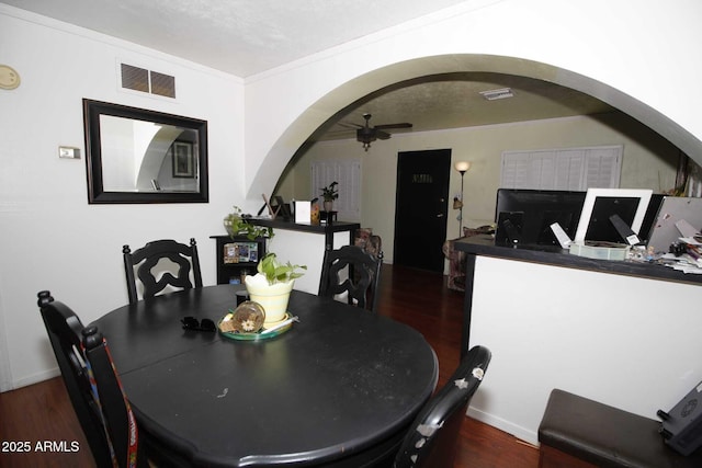 1211 E Fillmore St, Phoenix, AZ 85006 - dining room featuring arched walkways, dark wood-style floors, ceiling fan, and ornamental molding