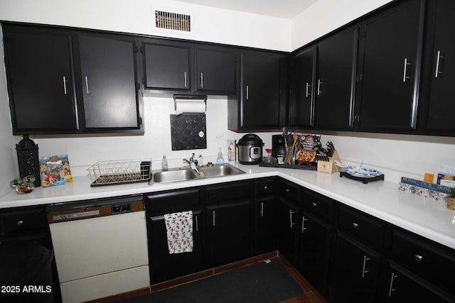 1211 E Fillmore St, Phoenix, AZ 85006 - kitchen with dark cabinets, white dishwasher, and light countertops
