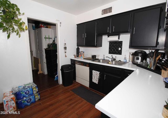 1211 E Fillmore St, Phoenix, AZ 85006 - kitchen with dark cabinets, white dishwasher, light countertops, and dark wood-style flooring