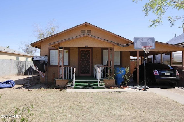 1211 E Fillmore St, Phoenix, AZ 85006 - view of front of house featuring covered porch, an attached carport, and stucco siding