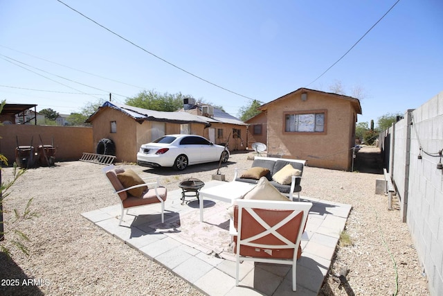 1211 E Fillmore St, Phoenix, AZ 85006 - rear view of house with a fenced backyard, a patio, and an outdoor living space with a fire pit