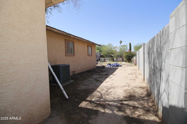 1211 E Fillmore St, Phoenix, AZ 85006 - view of side of property with a central AC unit and stucco siding