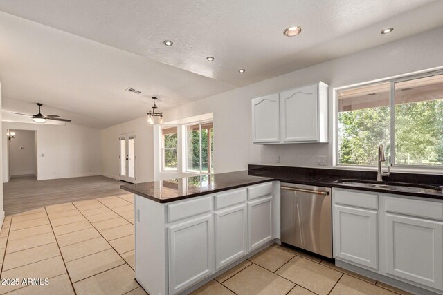 19006 E Karsten Dr, Queen Creek, AZ 85142 - kitchen with stainless steel dishwasher, a sink, vaulted ceiling, a peninsula, and light tile patterned floors