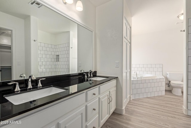 19006 E Karsten Dr, Queen Creek, AZ 85142 - full bath featuring wood finished floors, a garden tub, a tile shower, double vanity, and toilet