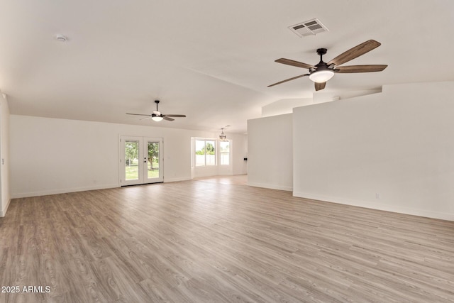 19006 E Karsten Dr, Queen Creek, AZ 85142 - unfurnished living room with ceiling fan, light wood finished floors, baseboards, and lofted ceiling