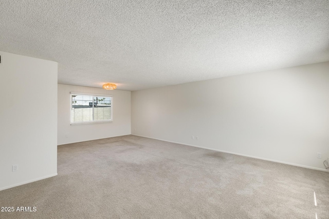 unfurnished room with light carpet and a textured ceiling