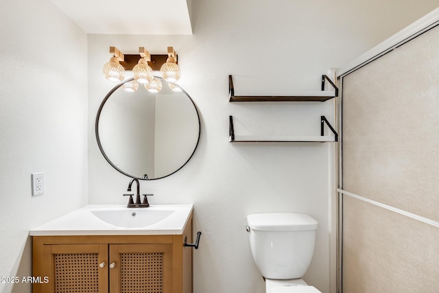 bathroom featuring vanity, toilet, and a chandelier