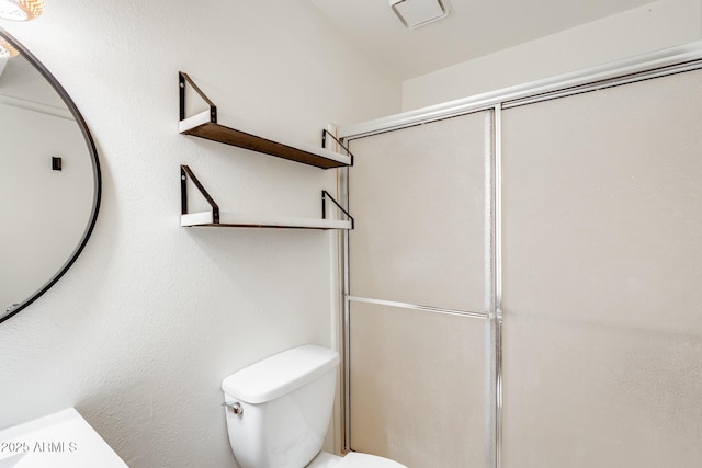 full bathroom with toilet and an enclosed shower