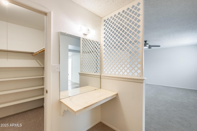 bathroom with a textured ceiling and a ceiling fan