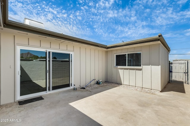 rear view of house featuring a patio area and board and batten siding