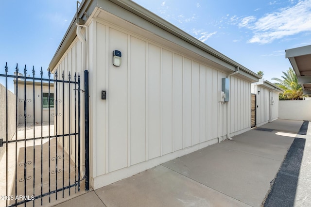 view of property exterior featuring a gate and board and batten siding