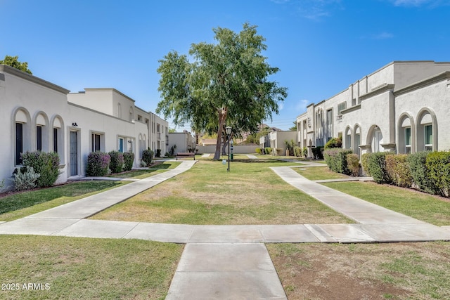 view of property's community featuring a residential view and a yard