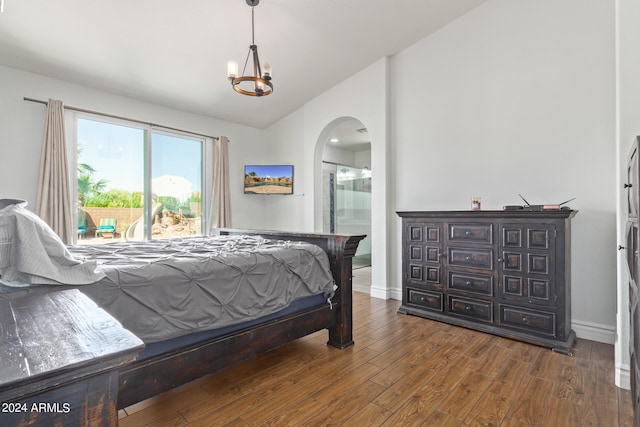 bedroom featuring vaulted ceiling, a chandelier, ensuite bathroom, and dark hardwood / wood-style floors