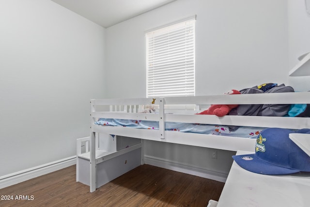 bedroom with dark wood-type flooring