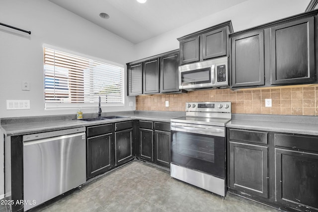 14521 W Gelding Dr, Surprise, AZ 85379 - kitchen with a sink, backsplash, dark cabinets, and appliances with stainless steel finishes