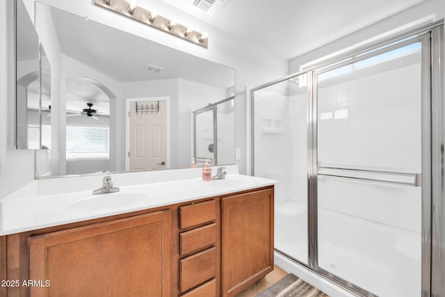 14521 W Gelding Dr, Surprise, AZ 85379 - full bath with a stall shower, double vanity, a sink, and a ceiling fan