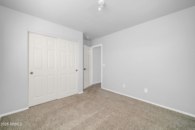 14521 W Gelding Dr, Surprise, AZ 85379 - unfurnished bedroom with carpet, a closet, and baseboards
