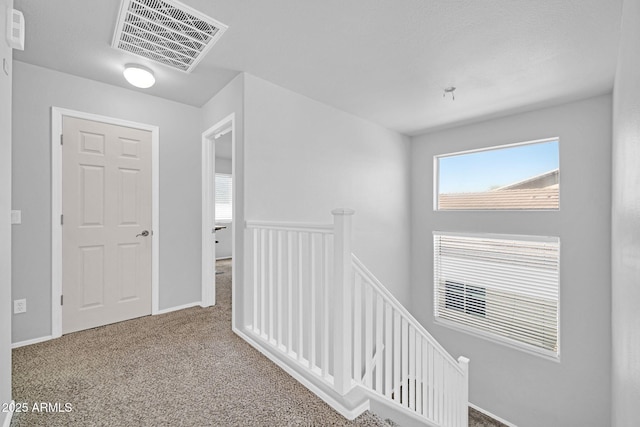 14521 W Gelding Dr, Surprise, AZ 85379 - corridor with carpet flooring, an upstairs landing, and visible vents