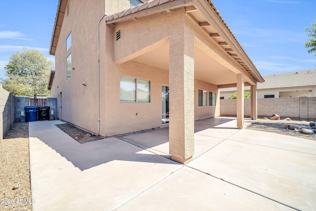 14521 W Gelding Dr, Surprise, AZ 85379 - rear view of property featuring a fenced backyard, stucco siding, and a patio