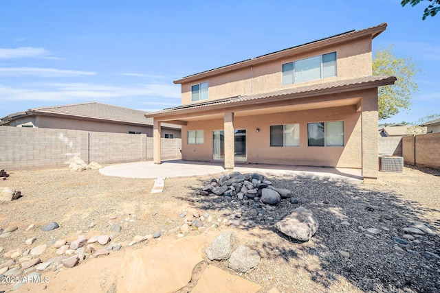14521 W Gelding Dr, Surprise, AZ 85379 - rear view of property featuring a fenced backyard, stucco siding, a tiled roof, and a patio area