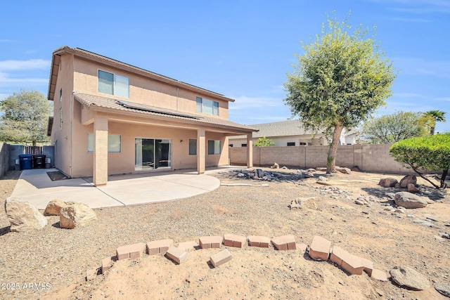 14521 W Gelding Dr, Surprise, AZ 85379 - back of property with a fenced backyard, stucco siding, a patio area, and solar panels