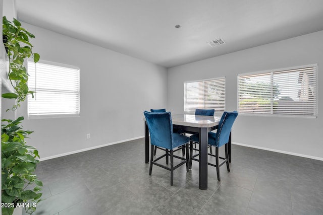 14521 W Gelding Dr, Surprise, AZ 85379 - dining area featuring dark tile patterned flooring, baseboards, and visible vents