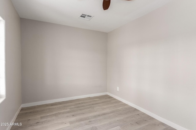 empty room with ceiling fan and light hardwood / wood-style floors