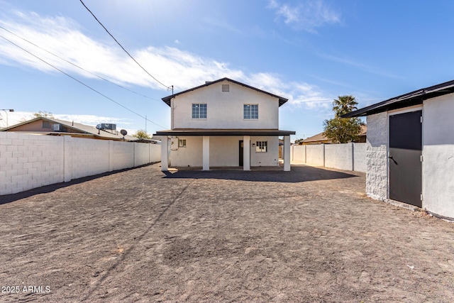 rear view of house with a patio