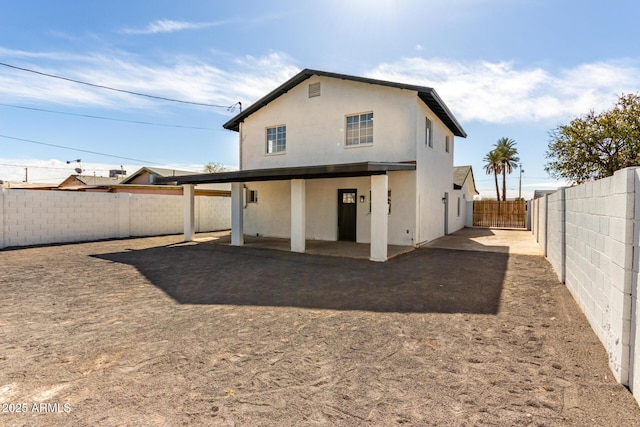 rear view of house featuring a patio area