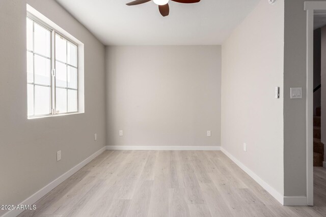 spare room featuring ceiling fan and light wood-type flooring