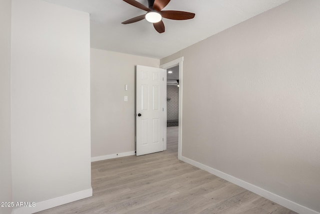 spare room featuring light hardwood / wood-style flooring and ceiling fan