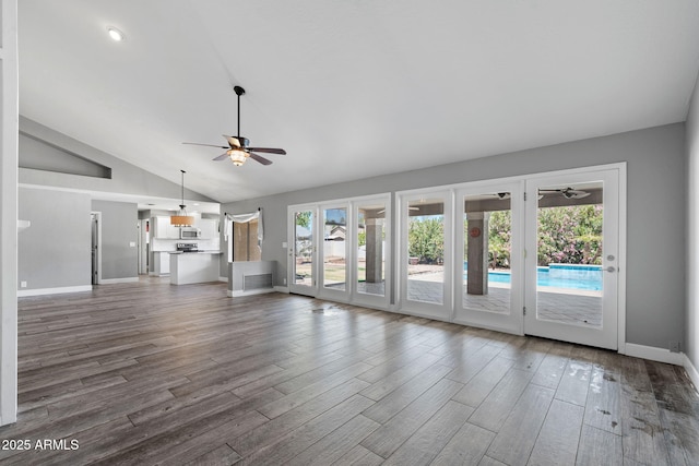 3822 E Florian Ave, Mesa, AZ 85206 - unfurnished living room featuring ceiling fan, healthy amount of natural light, vaulted ceiling, and dark wood-style flooring