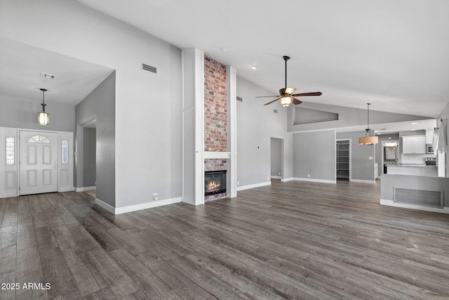 3822 E Florian Ave, Mesa, AZ 85206 - unfurnished living room with high vaulted ceiling, a ceiling fan, dark wood finished floors, a brick fireplace, and baseboards