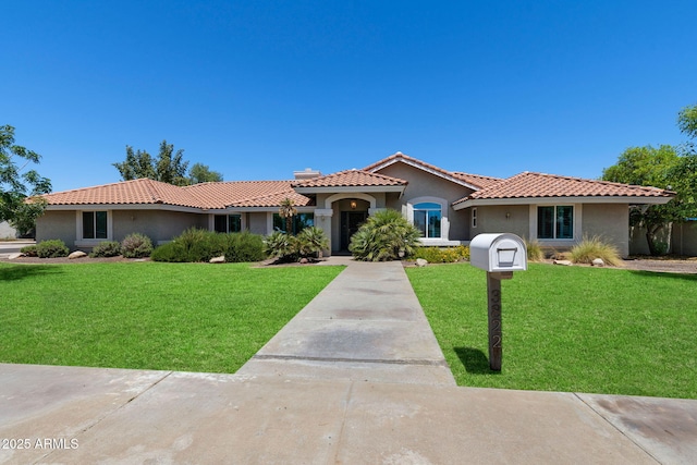 3822 E Florian Ave, Mesa, AZ 85206 - mediterranean / spanish-style home featuring stucco siding, a front yard, and a tiled roof