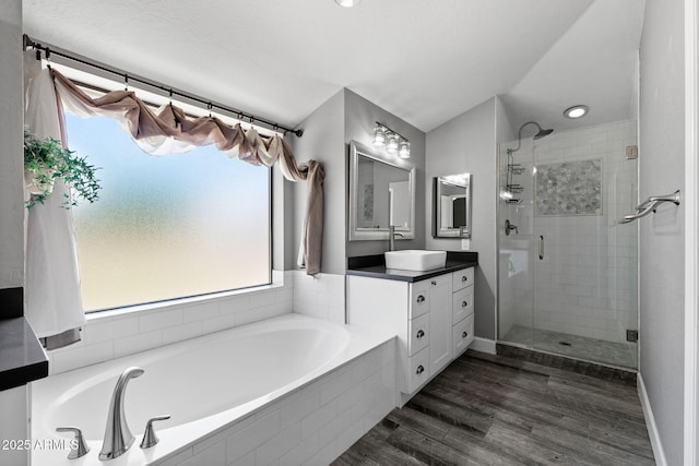 3822 E Florian Ave, Mesa, AZ 85206 - bathroom with a shower stall, plenty of natural light, a garden tub, and wood finished floors