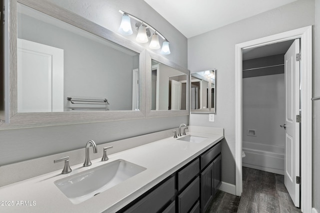 3822 E Florian Ave, Mesa, AZ 85206 - full bathroom featuring wood finished floors, double vanity, toilet, shower / bathtub combination, and baseboards