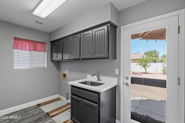 3822 E Florian Ave, Mesa, AZ 85206 - washroom featuring washer hookup, light wood-style flooring, plenty of natural light, and baseboards