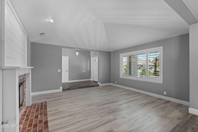 3822 E Florian Ave, Mesa, AZ 85206 - unfurnished living room featuring vaulted ceiling, wood finished floors, baseboards, and a fireplace
