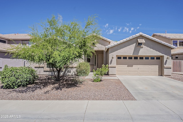 5926 W Questa Dr, Glendale, AZ 85310 - view of front facade with an attached garage, stucco siding, driveway, and a tile roof