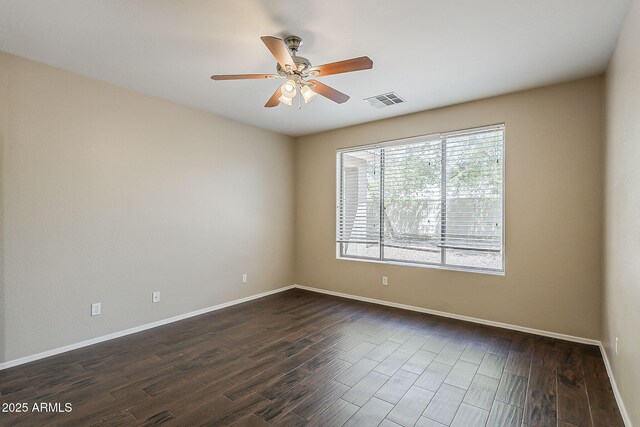 5926 W Questa Dr, Glendale, AZ 85310 - spare room with ceiling fan, visible vents, dark wood-style floors, and baseboards