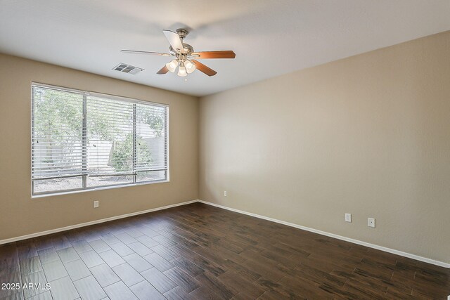 5926 W Questa Dr, Glendale, AZ 85310 - unfurnished room featuring visible vents, a ceiling fan, dark wood-style flooring, and baseboards