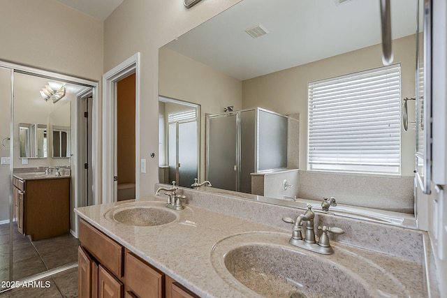5926 W Questa Dr, Glendale, AZ 85310 - bathroom featuring a sink, a shower stall, and double vanity