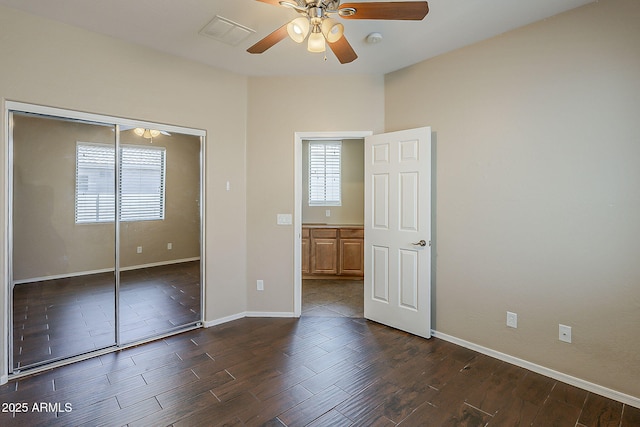 5926 W Questa Dr, Glendale, AZ 85310 - unfurnished bedroom with baseboards, a closet, dark wood finished floors, and visible vents