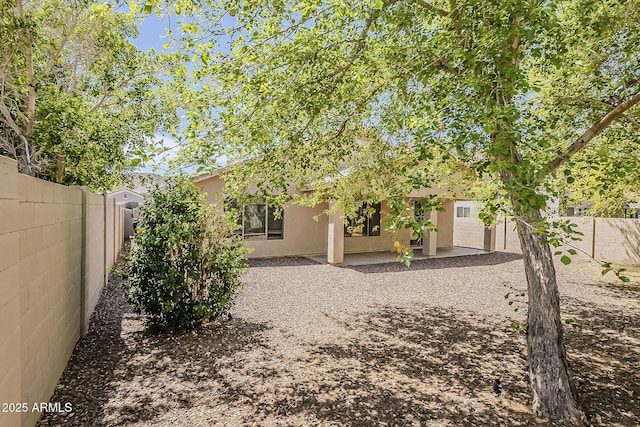 5926 W Questa Dr, Glendale, AZ 85310 - back of house with a fenced backyard, stucco siding, and a patio area