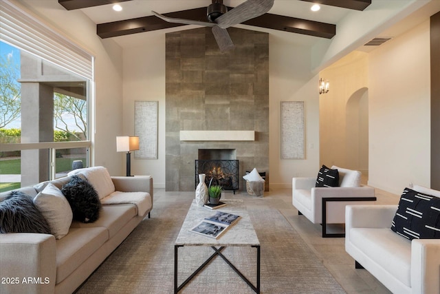 8599 E Sand Flower Dr, Scottsdale, AZ 85266 - living area featuring a towering ceiling, visible vents, a ceiling fan, arched walkways, and beam ceiling